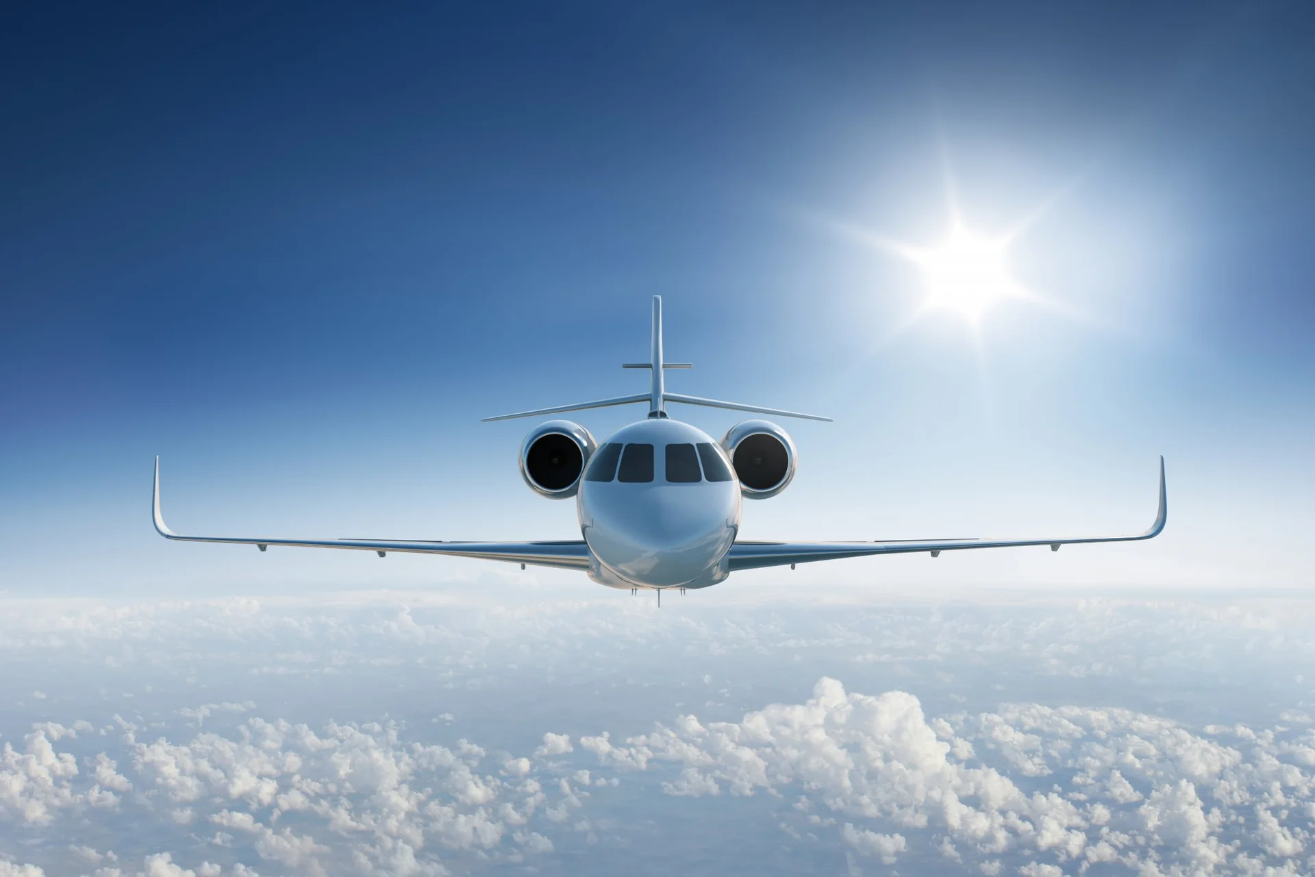 Private jet in flight above the clouds